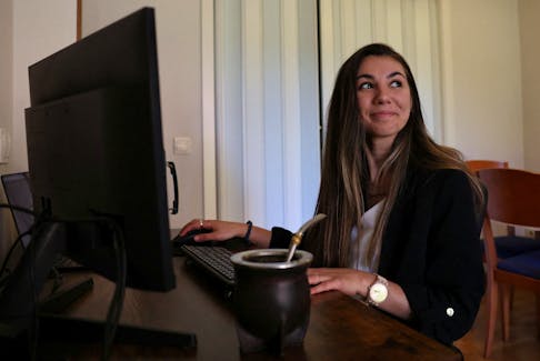 Argentinian postdoctoral researcher in distributed systems Marianela Morales poses for a portrait at her work station in her Madrid home, Spain, April 19, 2024.