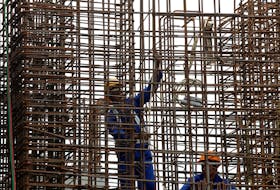 Labourers work at the construction site of a sky train station in Hanoi, Vietnam September 30, 2016.