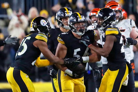 Dec 23, 2023; Pittsburgh, Pennsylvania, USA;  Pittsburgh Steelers teammates congratulate linebacker Alex Highsmith (56) on his interception against the Cincinnati Bengals during the fourth quarter at Acrisure Stadium. Pittsburgh won 34-11. Mandatory Credit: Charles LeClaire-USA TODAY Sports