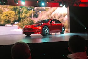 A Tesla Model 3 sedan, its first car aimed at the mass market, is displayed during its launch in Hawthorne, California, March 31, 2016.