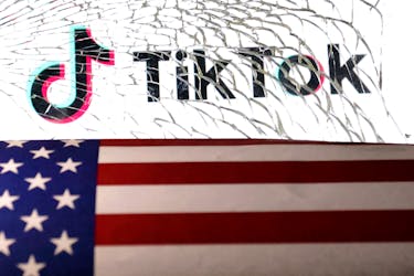 U.S. flag and TikTok logo are seen through broken glass in this illustration taken March 20, 2024.