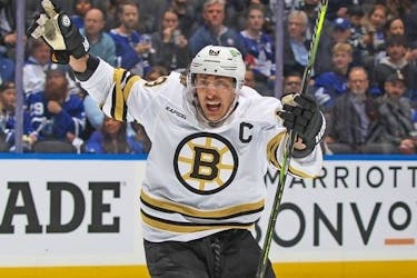 Brad Marchand #63 of the Boston Bruins celebrates a goal by Jake DeBrusk (not shown) against the Toronto Maple Leafs in Game Three of the First Round of the 2024 Stanley Cup Playoffs at Scotiabank Arena on April 24, 2024 in Toronto.. The Bruins defeated the Maple Leafs 4-2.