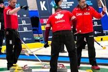 Team Canada members, from left, Peter Burgess, Martin Gavin and Kris Granchelli acknowledge a shot by skip Paul Flemming during action at the world senior men's curling championship in Ostersund, Sweden. The Halifax rink advanced to Friday's quarter-finals. - Curling Canada