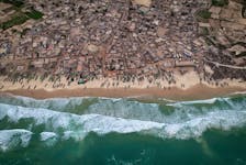 A drone view shows rows of fishermen's boats, known as pirogues, on the shore at Fass Boye, Senegal, February 1, 2024. Dozens of wooden fishing boats line Fass Boye's sandy beach, a sign of fishing's central role in the local economy. But like many coastal communities, the village about 100 km north of Senegal's capital, Dakar, has seen hundreds of its residents leave in search of more opportunity. Diminishing fish stocks and soaring living costs have made it hard to make ends meet, locals say. They blame overfishing by international trawlers and say their small boats can't compete.