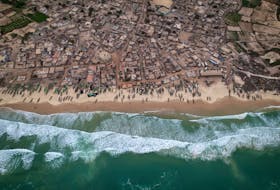 A drone view shows rows of fishermen's boats, known as pirogues, on the shore at Fass Boye, Senegal, February 1, 2024. Dozens of wooden fishing boats line Fass Boye's sandy beach, a sign of fishing's central role in the local economy. But like many coastal communities, the village about 100 km north of Senegal's capital, Dakar, has seen hundreds of its residents leave in search of more opportunity. Diminishing fish stocks and soaring living costs have made it hard to make ends meet, locals say. They blame overfishing by international trawlers and say their small boats can't compete.