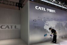 A staff member cleans a display showing the locations of battery maker CATL's production bases, at the CATL booth during the first China International Supply Chain Expo (CISCE) in Beijing, China November 28, 2023.