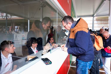 Tourists queue at the information center to register and receive a QR code to prove their payment of a fee for day trippers introduced by Venice municipality in a move to preserve the lagoon city often crammed with tourists in Venice, Italy, April 25, 2024.