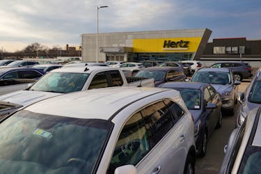Cars are parked near Hertz car rental signage at John F. Kennedy International Airport in Queens, New York City, U.S., March 30, 2022.
