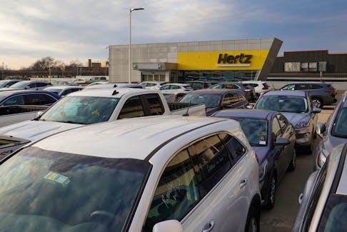 Cars are parked near Hertz car rental signage at John F. Kennedy International Airport in Queens, New York City, U.S., March 30, 2022.