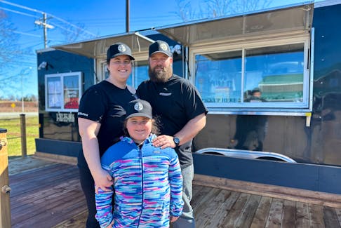 Natasha Perry joins her husband, Derek, and their seven-year-old daughter, Madelyn, in front of their new business, Dreadnaught Eatery, in Morell. Thinh Nguyen • The Guardian