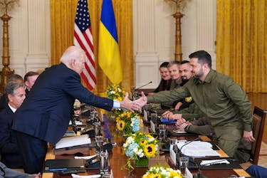U.S. President Joe Biden and Ukraine President Volodymyr Zelenskiy shake hands across the table during a meeting in the East Room of the White House in Washington, U.S. September 21, 2023.