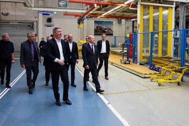 German Chancellor Olaf Scholz walks with Mathias Geisen, Head of the Mercedes-Benz Vans, Joerg Burzer, Member of the Board of Management of Mercedes-Benz and Dr. Markus Keicher, head of production and site at the Mercedes-Benz Ludwigsfelde plant, as he visits the production site of Mercedes Benz Ludwigsfelde GmbH in Ludwigsfelde in the south of Berlin, Germany, April 28, 2023.