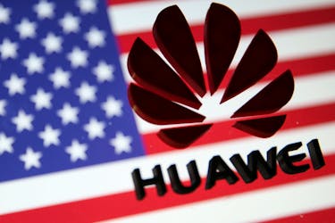 A 3D printed Huawei logo is placed on glass above displayed US flag in this illustration taken January 29, 2019.