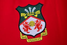 The club badge is pictured on a team shirt in the club shop at Wrexham Football Club in Wrexham, Britain, September 24, 2020.
