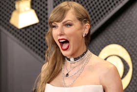 Taylor Swift poses on the red carpet as she attends the 66th Annual Grammy Awards in Los Angeles, California, U.S., February 4, 2024. 