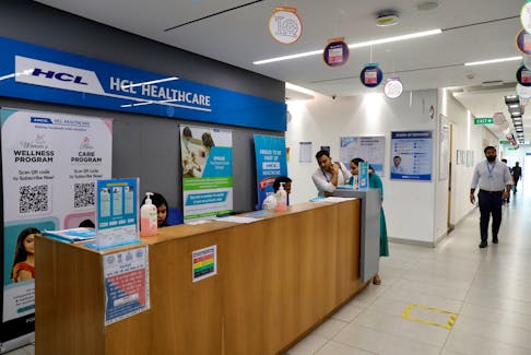 Employees stand at a front desk of healthcare section of HCLTech inside its office building on the outskirts of Lucknow, India, March 20, 2024.