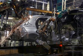 A welding robot assembles bodyworks on a Yaris car at the assembly line of the Toyota Motor Manufacturing France (TMMF) plant in Onnaing near Valenciennes, France, March 30, 2023.