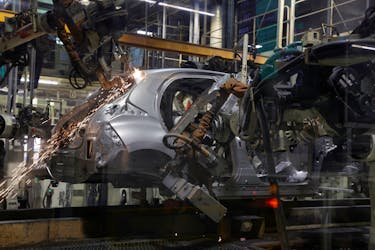 A welding robot assembles bodyworks on a Yaris car at the assembly line of the Toyota Motor Manufacturing France (TMMF) plant in Onnaing near Valenciennes, France, March 30, 2023.