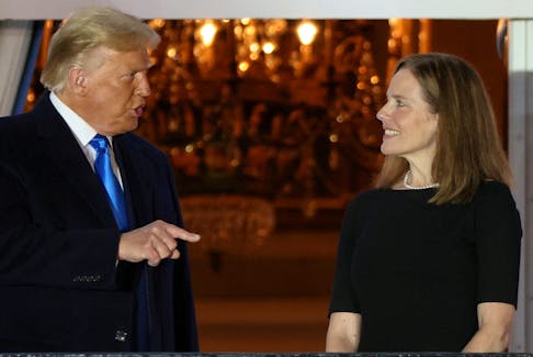 U.S. President Donald Trump speaks with Judge Amy Coney Barrett after she was sworn in as an associate justice of the U.S. Supreme Court on the South Lawn of the White House in Washington, U.S. October 26, 2020. 