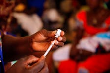 A nurse prepares to administer a malaria vaccine to an infant at the health center in Datcheka, Cameroon January 22, 2024.