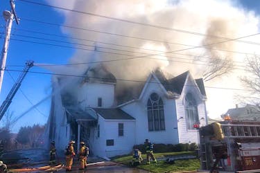 Firefighters battle a fire at the Bridgetown Baptist Church April 26.