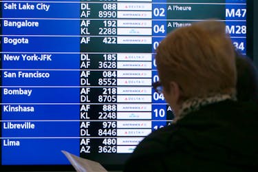 A flight departure screen displays information at the Roissy-Charles de Gaulle International Airport north of Paris January 26, 2014.