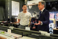 U.S. Secretary of State Antony Blinken talks with Yuxuan Zhou during a visit to Li-Pi record store in Beijing, China, April 26, 2024.     Mark Schiefelbein/Pool via REUTERS