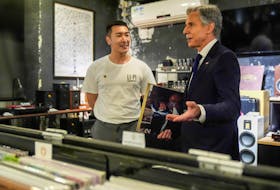 U.S. Secretary of State Antony Blinken talks with Yuxuan Zhou during a visit to Li-Pi record store in Beijing, China, April 26, 2024.     Mark Schiefelbein/Pool via REUTERS