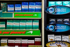 Newport and Camel cigarettes are stacked on a shelf inside a tobacco store in New York July 11, 2014.