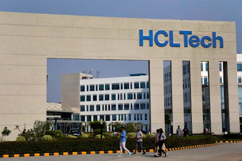 Employees of HCLTech walk inside the office premises on the outskirts of Lucknow, India, March 20, 2024.