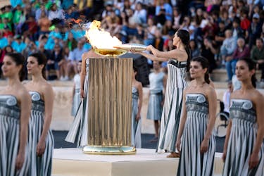 Paris 2024 Olympics - Olympic Flame Handover Ceremony - Panathenaic Stadium, Athens, Greece - April 26, 2024 Greek actress Mary Mina, playing the role of High Priestess, holds an olympic torch by the cauldron during the Handover Ceremony