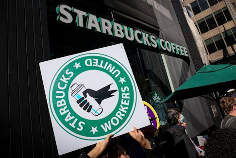 Members of the Starbucks Workers Union and other labor organization picket and hold a rally outside a company owned Starbucks store, during the coffee chain's Red Cup Day event in New York City, U.S., November 16, 2023. 
