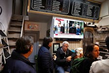 Spain's Prime Minister Pedro Sanchez and his wife Begona Gomez appear on a news channel in a bar, following his decision to suspend public duties after the court launched a preliminary investigation into his wife, in Bilbao, Spain, April 25, 2024.