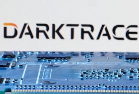 Darktrace logo is seen near computer motherboard in this illustration taken January 8, 2024.