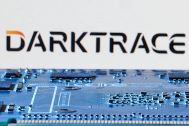 Darktrace logo is seen near computer motherboard in this illustration taken January 8, 2024.