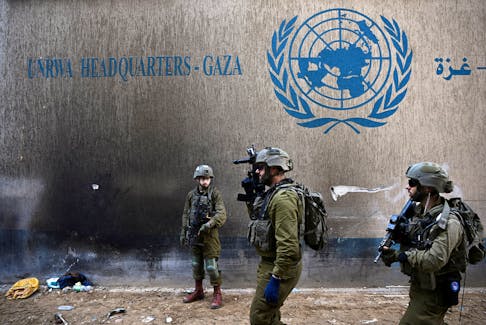 Israeli soldiers operate next to the UNRWA headquarters, amid the ongoing conflict between Israel and the Palestinian Islamist group Hamas, in the Gaza Strip, February 8, 2024.