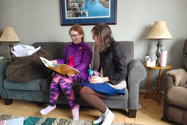 Charlotte Doyle and Leah McDonald rehearsing their play, 'Understanding Wonderland' in Doyle's living room. The play is a fresh take on Alice in Wonderland and is intended to better help those understand what it's like to live with autism. - Contributed