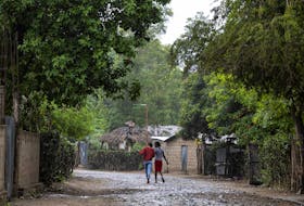 Women walk under the rain in the Malfety neighborhood of Fort Liberte, Haiti April 27, 2024.