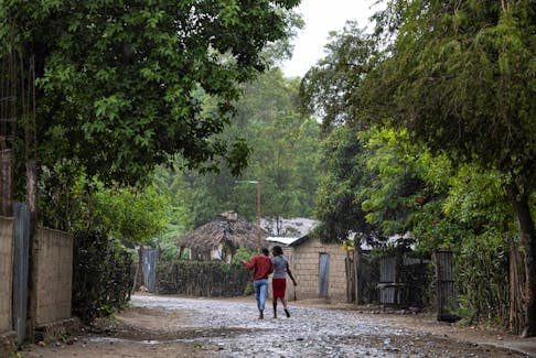 Women walk under the rain in the Malfety neighborhood of Fort Liberte, Haiti April 27, 2024.