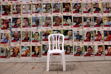 A chair is left in front of posters with pictures of hostages, who were kidnapped during the deadly October 7 attack on Israel by Palestinian Islamist group Hamas, amid the ongoing conflict in Gaza between Israel and Hamas, in Tel Aviv, Israel, April 26, 2024.