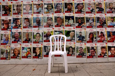 A chair is left in front of posters with pictures of hostages, who were kidnapped during the deadly October 7 attack on Israel by Palestinian Islamist group Hamas, amid the ongoing conflict in Gaza between Israel and Hamas, in Tel Aviv, Israel, April 26, 2024.
