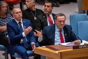 Israel Katz, Foreign Minister to the United Nations points at family members of hostages in the audience during a meeting of the United Nations Security Council on the conflict between Israel and Hamas, at U.N. headquarters in New York, U.S., March 11, 2024.