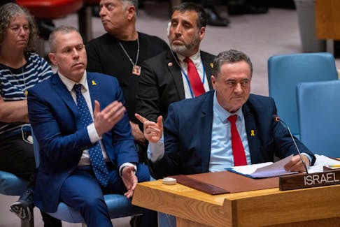 Israel Katz, Foreign Minister to the United Nations points at family members of hostages in the audience during a meeting of the United Nations Security Council on the conflict between Israel and Hamas, at U.N. headquarters in New York, U.S., March 11, 2024.