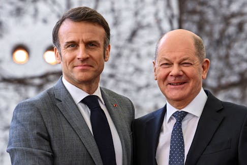 German Chancellor Olaf Scholz welcomes French President Emmanuel Macron before their trilateral meeting with Polish Prime Minister Donald Tusk for the consultation forum 'Weimar Triangle', at the Chancellery in Berlin, Germany March 15, 2024.