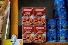 Boxes of Everest fish curry masala are stacked on the shelf of a shop at a market in Srinagar, April 23, 2024.