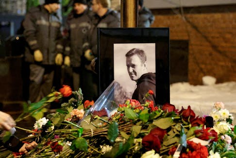 People lay flowers at the grave of Russian opposition politician Alexei Navalny following his funeral at the Borisovskoye cemetery in Moscow, Russia, March 1, 2024.