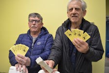Northside 4 Chase the Ace chair Craig Ivey, left, and North Sydney Food Bank executive director Lawrence Shebib. The draw is down to the last three cards this week. BARB SWEET/CAPE BRETON POST