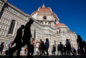 People walk past the Cathedral Santa Maria del Fiore in Florence, Italy April 13, 2024.