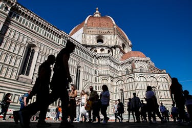 People walk past the Cathedral Santa Maria del Fiore in Florence, Italy April 13, 2024.