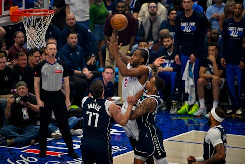 Apr 26, 2024; Dallas, Texas, USA; LA Clippers forward Kawhi Leonard (2) shoots the ball over Dallas Mavericks guard Luka Doncic (77) during the first quarter during game three of the first round for the 2024 NBA playoffs at the American Airlines Center. Mandatory Credit: Jerome Miron-USA TODAY Sports